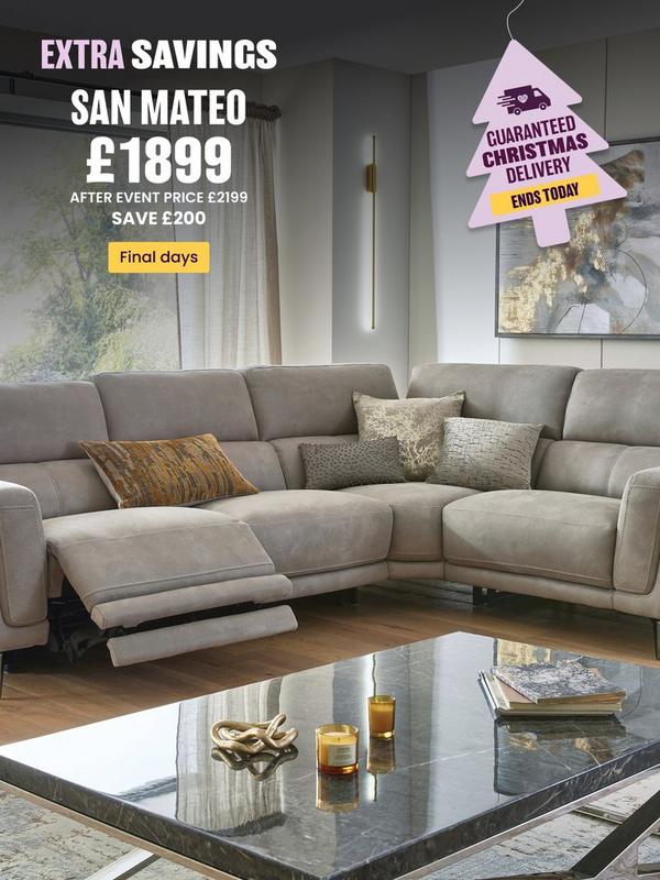 Stone coloured corner sofa with reclining features on footrest with selection of scatter cushions