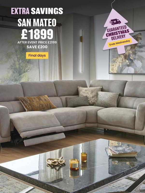 Stone coloured corner sofa with reclining features on footrest with selection of scatter cushions