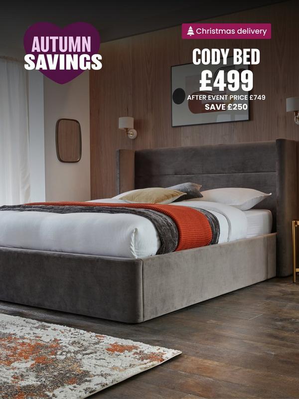 grey bed with straight edges on headcoard in a wooden panelled room