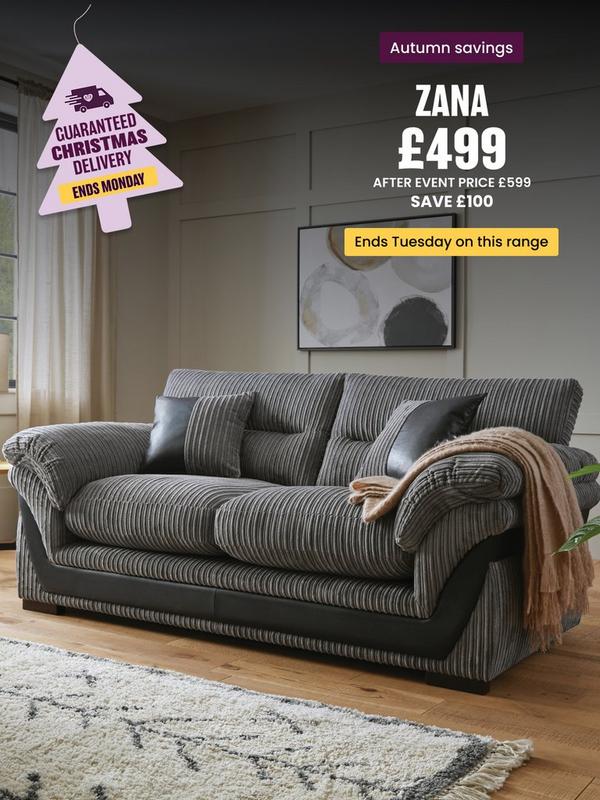 grey cord sofa with faux leather detailing on a wooden floored room setting