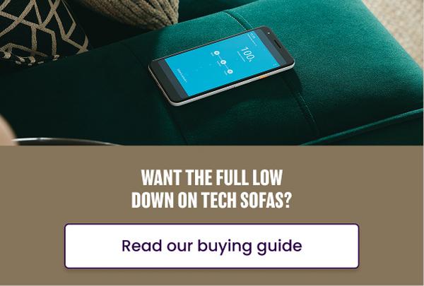mobile phone on the arm of a green sofa with built in wireless charging
