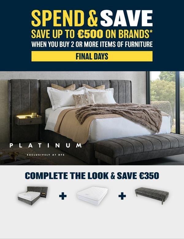A large hotel style bed with large footstool