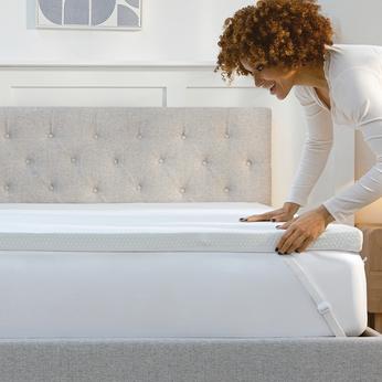 Person pulling on a mattress topper