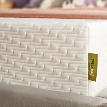 Side view of a mattress on a bed