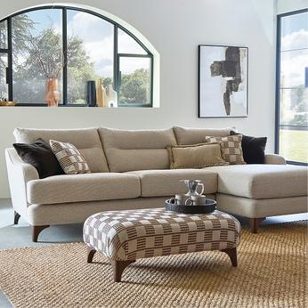 black sofa and a patterned footstool
