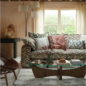 zebra print sofa with a glass and walnut coffee table