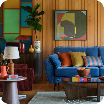 bright blue sofa in a retro styled room with wood panelled walls