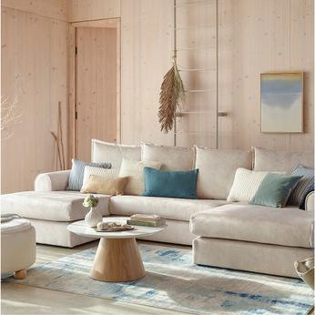 cream coloured u shaped sofa with light pine coloured walls