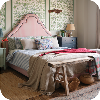 a country house-styled room with a red striped bed frame