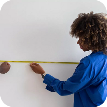 person measuring a wall