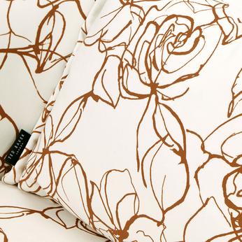 Close up of a cream chair with floral pattern detail