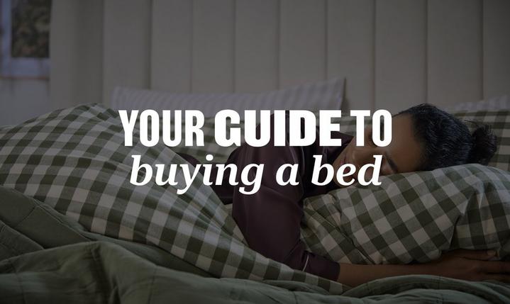 person laying in bed, wrapped in a quilt