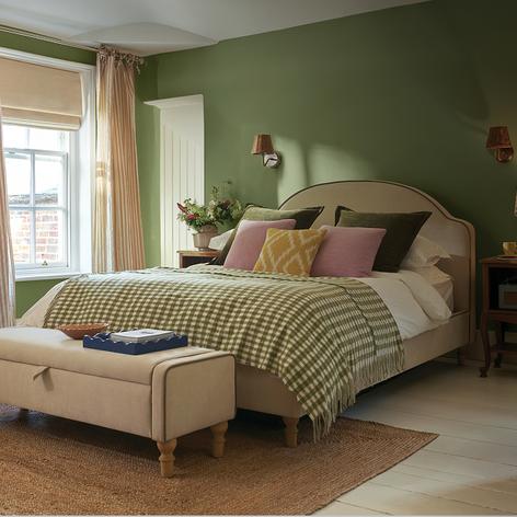 cream bed with olive green checked throw
