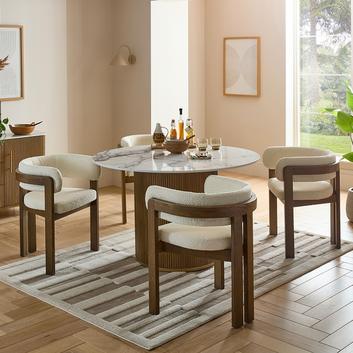 white fabric dining chairs under a round dining table