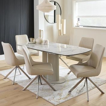 6 white leather dining chairs under a marble effect dining table