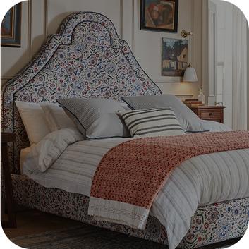 large bed with a floral designed headboard