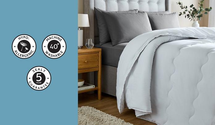 a duvet on a cream bedframe