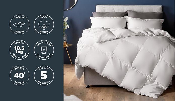 a duvet on a cream bedframe