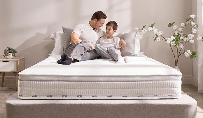 adult and child sat on bed