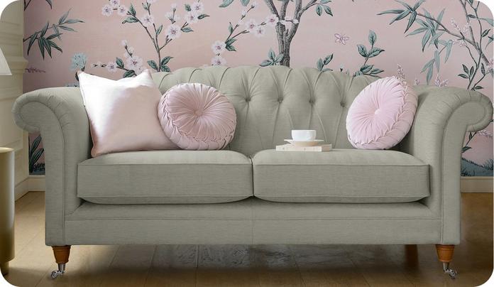 grey chesterfield sofa with light pink scatter cushions