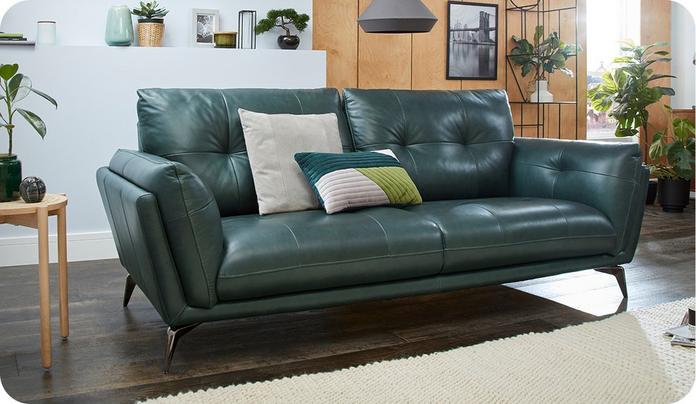dark green leather sofa on a dark wood floor