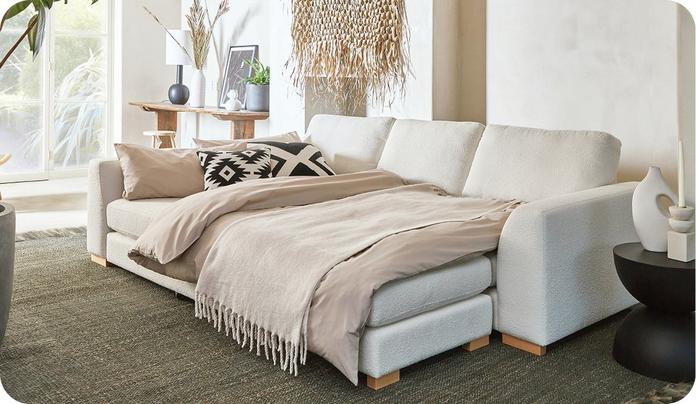 large white corner sofa transformed into a sofa bed