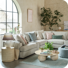 cream corner sofa in a pastel themed room