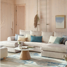 cream u shaped sofa in a coastal themed room