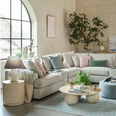 cream corner sofa in a pastel themed room