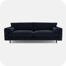 Navy blue misd century sofa with black legs and round bolster cushions