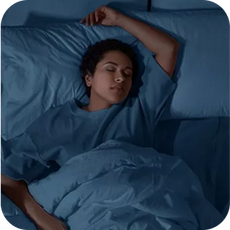 person in blue laying in bed