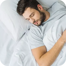 person lying on their back in bed