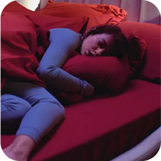 a person in bed wrapped in their duvet