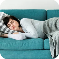 a person sleeping on their side on the sofa