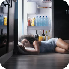 a person sleeping in front of an open fridge to keep cool