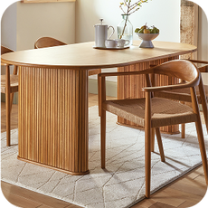 wooden dining table surrounded by chairs