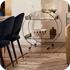 bar cart next to dining chairs