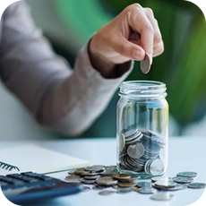Person putting coins into a jar