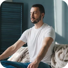 person sitting cross legged on a sofa