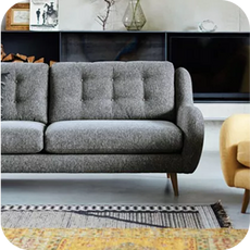 grey sofa next to a yellow accent chair