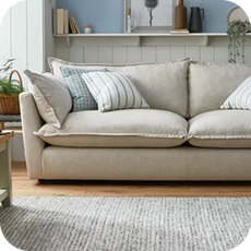 a large cream sofa in a wood-panelled room