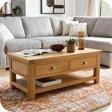 A small grey corner sofa with an oak coffee table