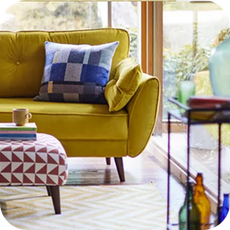 a bright yellow sofa in a well lit room