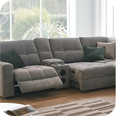 A large grey recliner and electric chaise sofa with built-in speakers