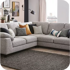 A large grey corner sofa with scatter cushions