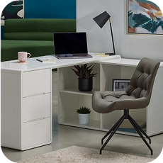 a white corner desk with grey office chair