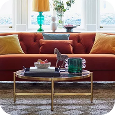 a bright orange sofa with yellow scatter cushions