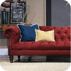 a deep red velvet chesterfield sofa