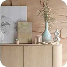 a light oak sideboard with decorative ornaments