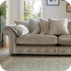 a cream chesterfield sofa with scatter back